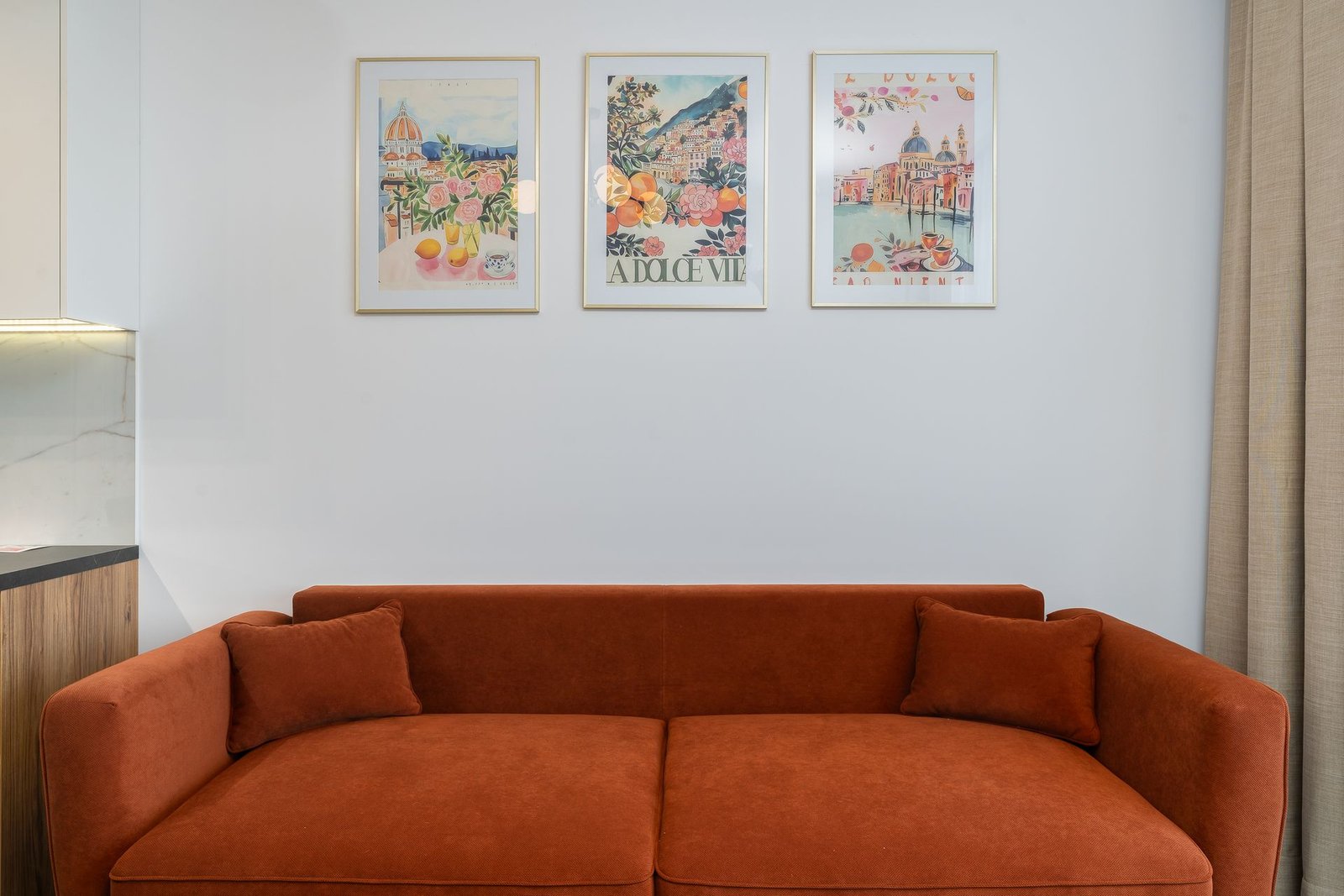 Living room interior with curated art and warm sofa